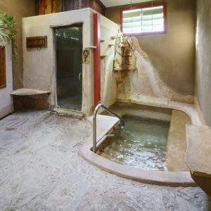 The Wet Room - hot mineral water soaking pool with steam room and waterfalls at Blackstone Hotsprings