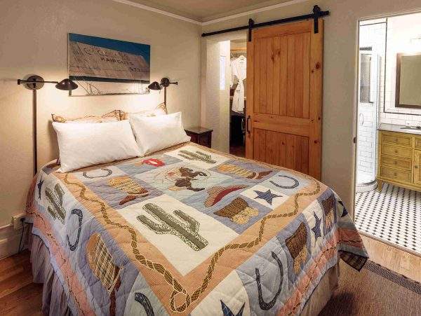 queen bed and separate bath in the Lone Ranger room at Blackstone