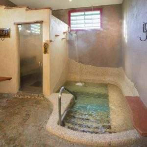 The Wet Room - hot mineral water soaking pool with steam room and waterfalls at Blackstone Hotsprings